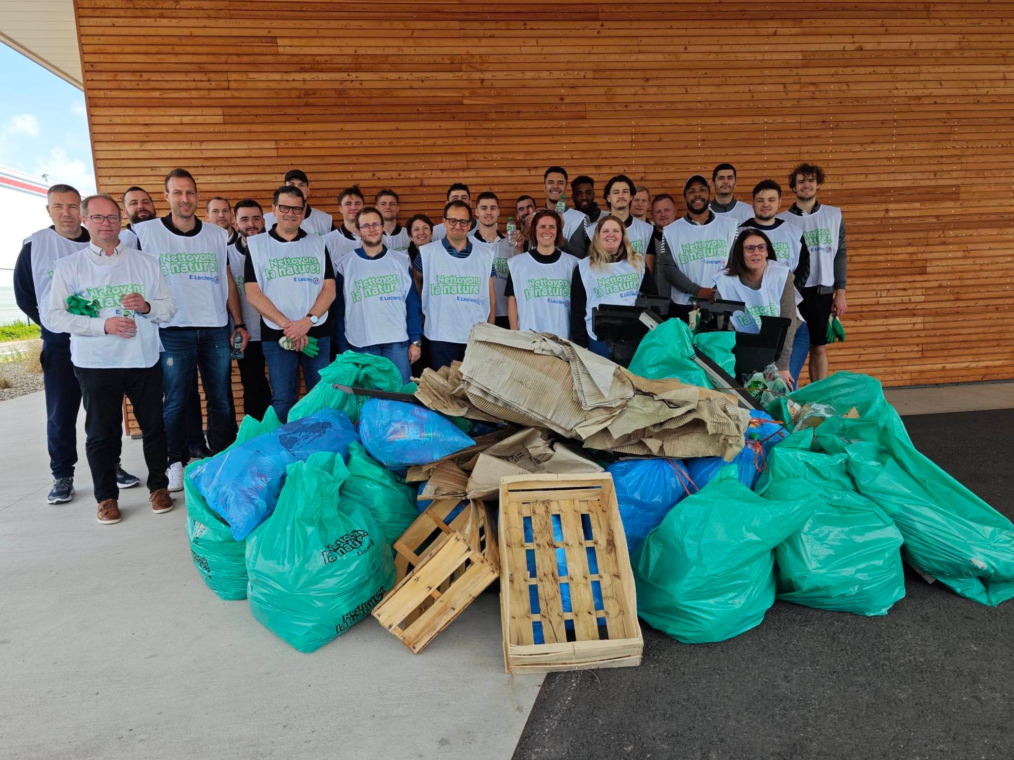 Les joueurs pros du SAHB, les salariés de E.Leclerc Sélestat et de Peugeot Sélestat posent devant 173 kilos de déchets ramassés en ZI Nord de Sélestat